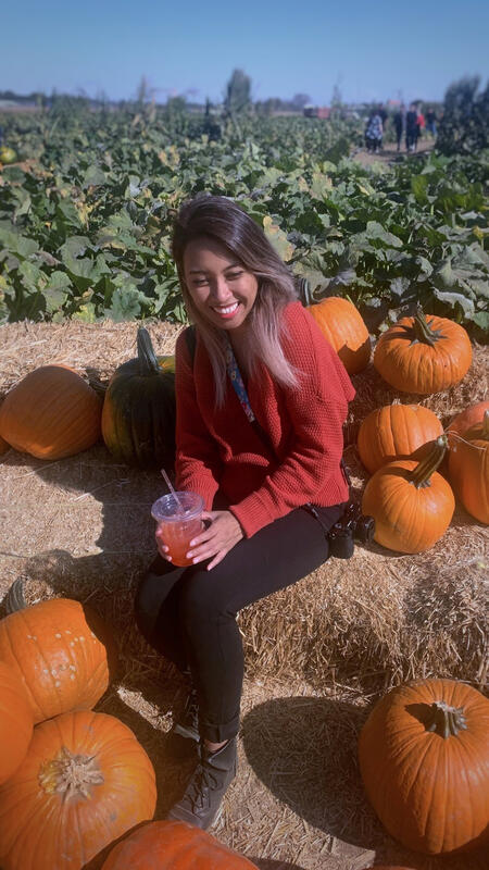 Portrait of Sotara surrounded by orange pumpkins